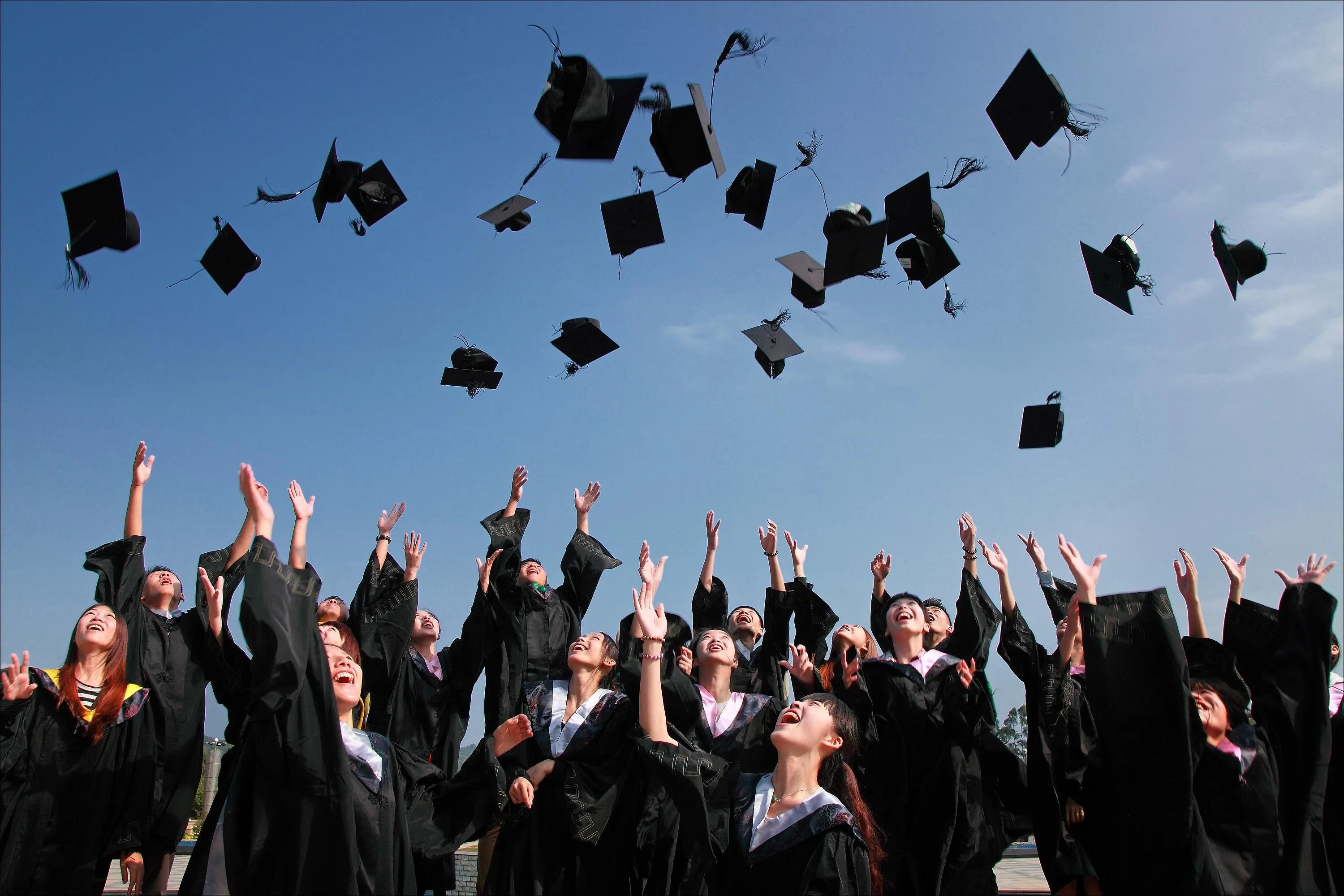 graduates-throwing-scholar-hat-in-the-air